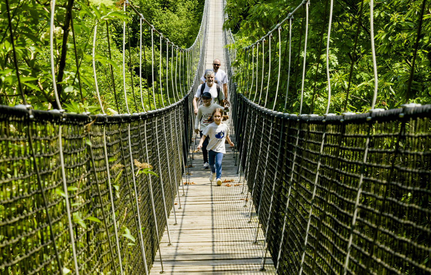 Group crossing a suspension bridge in Irrisarri Land