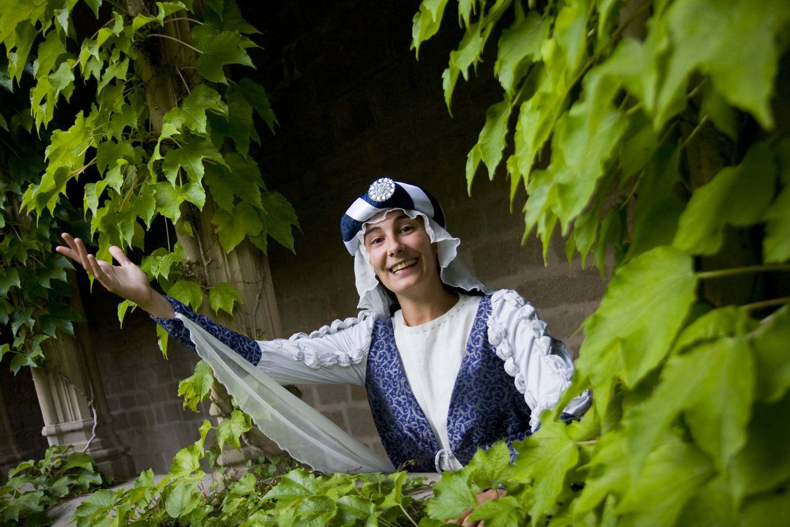 Una dama medieval saluda desde un balcón del Palacio Real